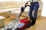 vacuuming hardwood floor with a rug